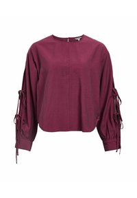 Blusa corta burdeos con un escote redondo, mangas amplias y detalles de lazo en los puños, que cuenta con una cremallera en la parte posterior.