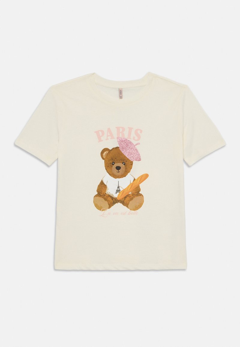 T-shirt de algodão creme com uma ilustração de um urso, um boné rosa, uma baguete e o texto "PARIS" e "La vie est belle" em rosa.