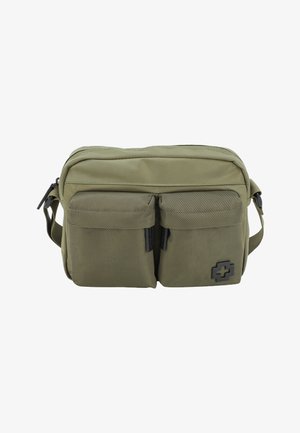 Bolso cruzado de color verde oliva hecho de tela resistente, con dos bolsillos frontales, un compartimento principal con cremallera y un acento de logo negro.