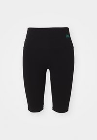 Leggings neri fino al ginocchio con una cintura larga, realizzati in materiale elastico, con un piccolo logo teal sul lato.
