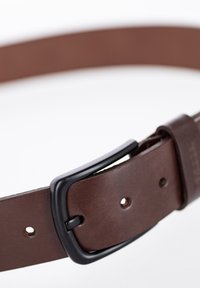 Cinturón de cuero marrón con una textura suave, que cuenta con una hebilla de metal negro y agujeros para ajuste. Diseño simple, adecuado para varios conjuntos.
