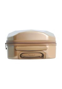 Gold hard-shell suitcase with textured surface, a zipper opening, and a top handle. Features an embossed logo and angular design.