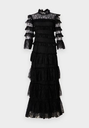 Rochie neagră din dantelă cu volane suprapuse. Gât înalt și mâneci lungi, transparente. Țesătură texturată cu detalii intricate și un design în trepte.