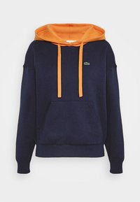 Navy blue hoodie with orange hood lining and drawstrings, front kangaroo pocket, and small green crocodile logo on left chest.