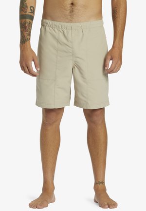 Beige swim shorts with an elastic waistband, knee-length design, side pockets, and flat seams. Made of lightweight, water-resistant material.