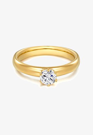 Złoty pierścionek z gładką, zaokrągloną obrączką i wyraźnym okrągłym diamentem osadzonym w sześciu szponach na środku.