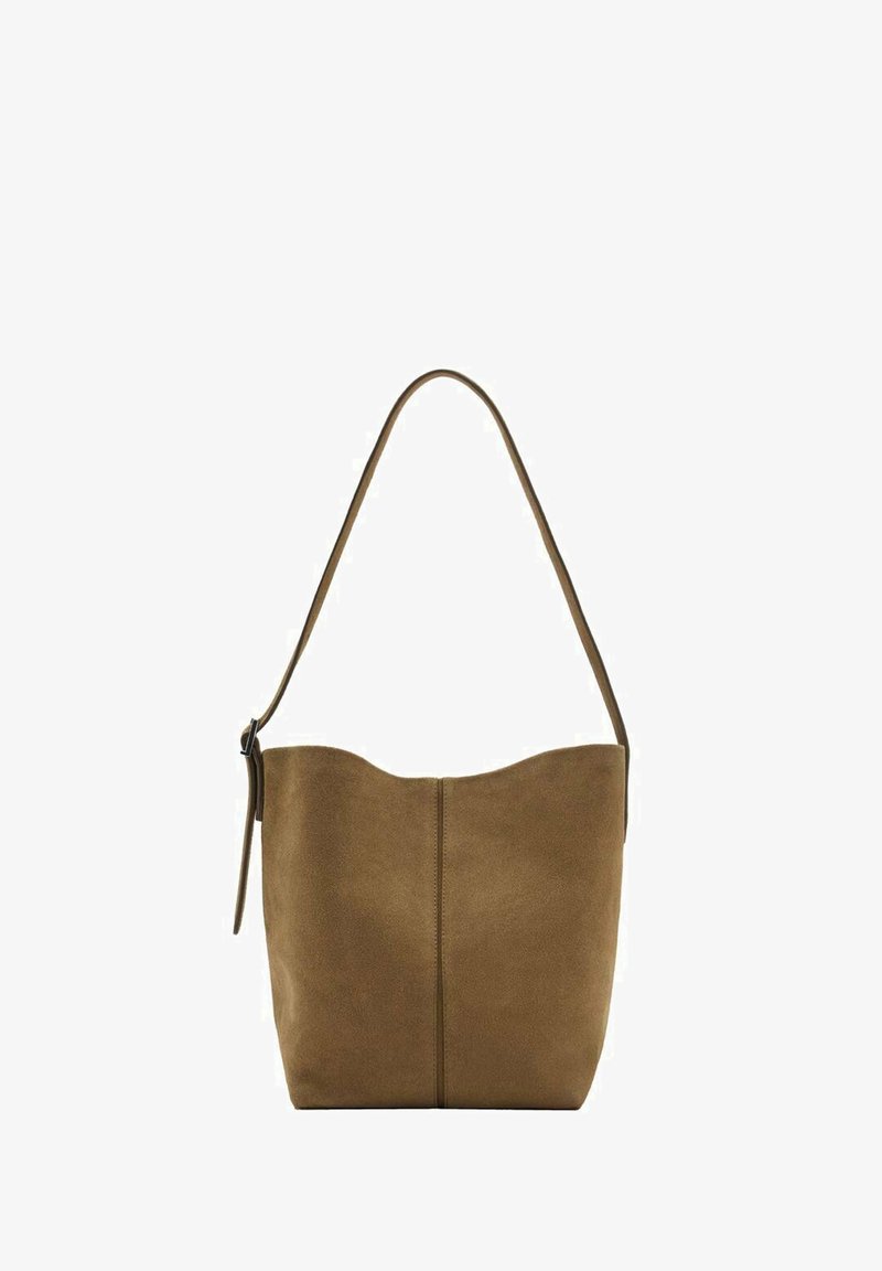 Brown suede shoulder bag with a curved top, single strap, and a central seam detail. Soft texture enhances the minimalist design.
