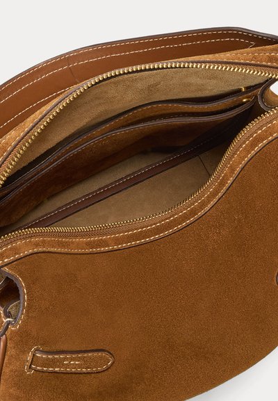 Brown suede handbag with gold zipper partially open, showing multiple internal compartments and smooth leather lining.