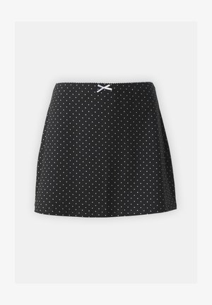 Fustă neagră cu buline albe, având un fular plisat la talie și o mică panglică decorativă în față. Design scurt și evazat.