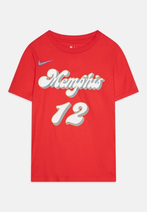 Red cotton t-shirt featuring "Memphis" in white and blue with a perforated "12" design. Nike logo in blue on the shoulder. Short sleeves.