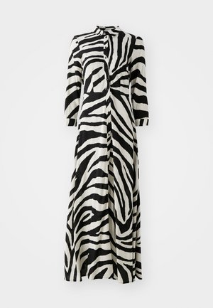 Long button-up dress in black and white zebra print, featuring 3/4 sleeves, a collar, and a straight cut design. Made of lightweight fabric.