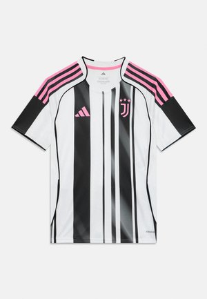 Camisa de fútbol a rayas en blanco y negro con acentos rosas en los hombros. Hecha de material ligero, con cuello redondo y logo.