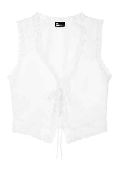 White sleeveless crop top with a deep V-neck, featuring ruffle accents along the edges and a front tie closure. Scalloped hem detail.