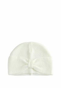 Knit white baby beanie with a ribbed texture, featuring a large bow detail at the front. Flexible and soft material.
