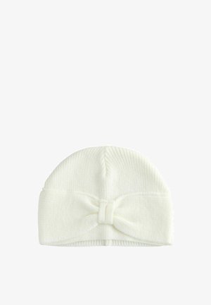 Gestrickte weiße Baby-Mütze mit einem gerippten Design, das an der Vorderseite ein großes Schleifendetail aufweist. Flexibles und weiches Material.