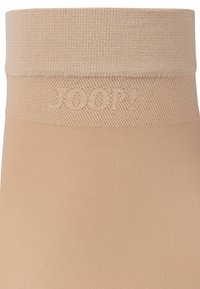 Collant color carne con una vita strutturata caratterizzata dal logo in rilievo "JOOP!" e una parte gamba liscia e trasparente.