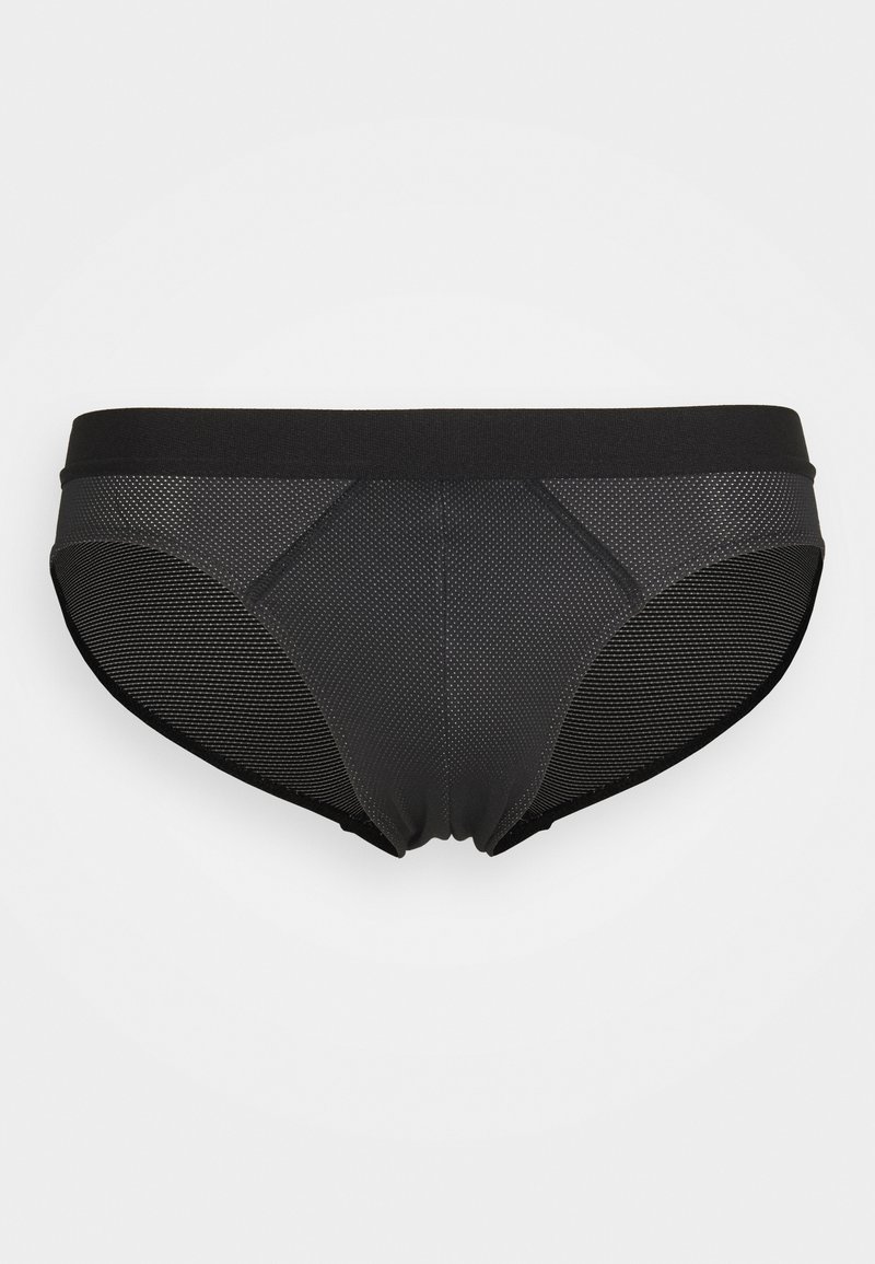 Zwarte short gemaakt van gaas en solide stof. Heeft een brede elastische tailleband en getextureerde panelen voor ademend vermogen en comfort.