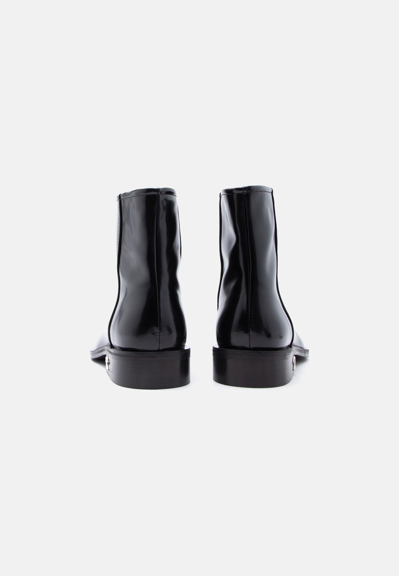 Pair of glossy black ankle boots viewed from the back on a plain white background.