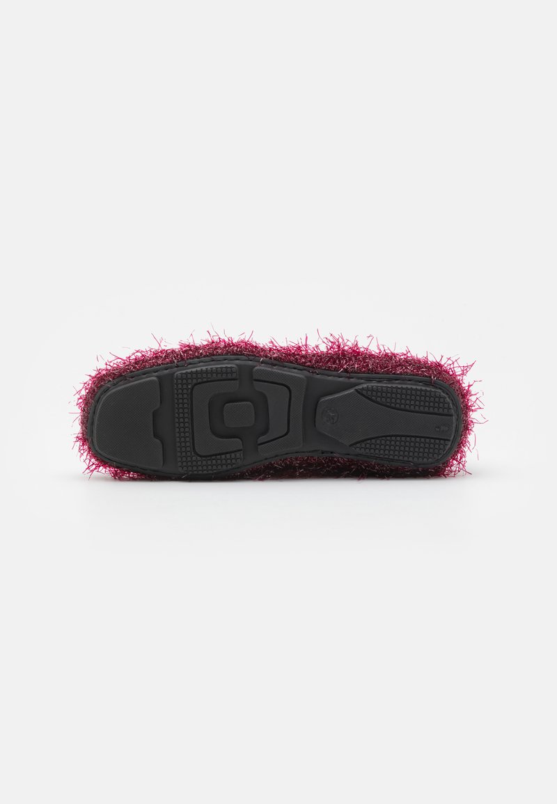 Fuzzy pink slipper with a textured upper, featuring a black rubber sole with grip patterns and a molded heel for comfort.