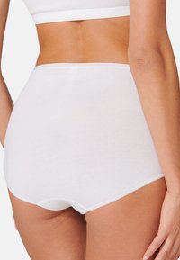 Sous-vêtements blancs en coton taille haute avec une texture lisse, une taille élastique et un design sans coutures, présentant un style simple et minimaliste.
