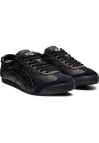 Black leather and suede sneakers with a smooth finish and textured overlay, featuring round laces and a low-profile rubber sole.
