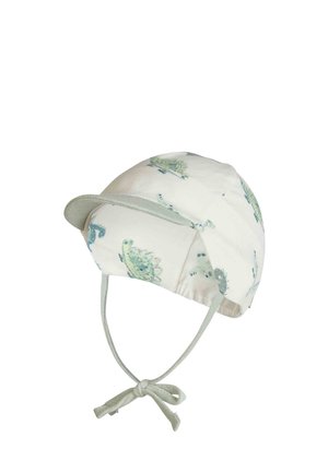 White baby cap with green dinosaur prints, soft fabric, tied chin straps, and a small brim for sun protection.