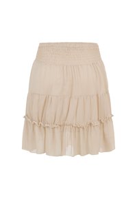 Jupe beige à étages avec taille smockée élastique et détail volanté autour de l'étage du milieu, en tissu léger.
