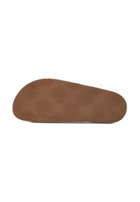 Bruine rubberen schoenzool met een gestructureerd oppervlak, met cirkelvormige en hexagonale patronen voor grip, aflopend naar een afgeronde voorrand.