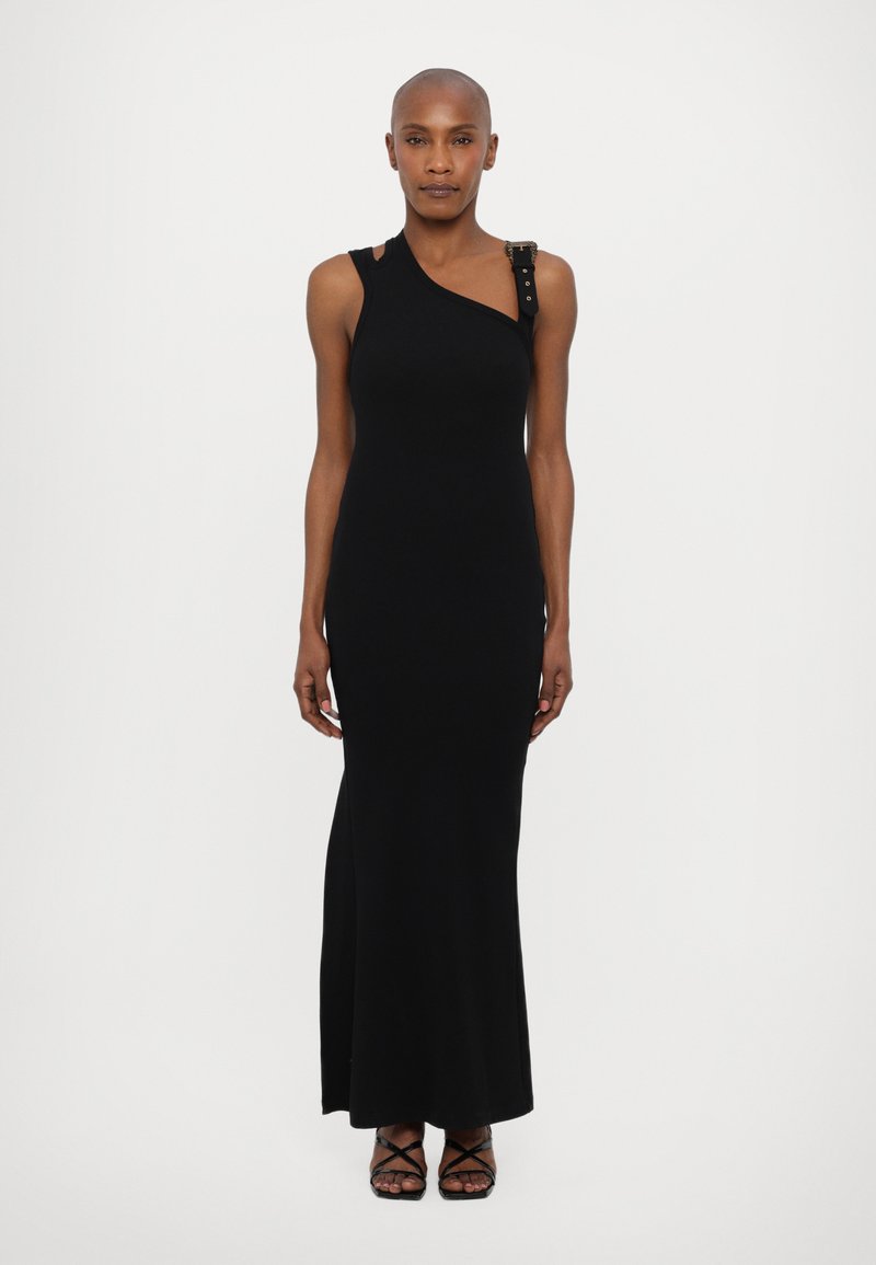 Black, asymmetrical, sleeveless dress with a textured shoulder accent featuring decorative hardware. Smooth, form-fitting fabric, floor-length design.