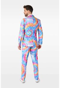 Colorful tie-dye suit featuring vibrant swirls of pink, blue, and yellow. Material appears lightweight with a fitted design and blazer details.