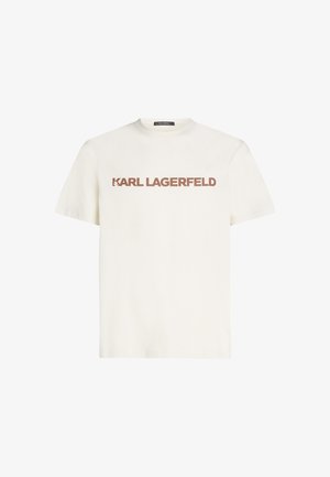 Balta kokvilnas T-kreklu ar īsām piedurknēm, ar izteiksmīgu brūnu tekstu "KARL LAGERFELD" uz priekšpuses. Apaļš kakla izgriezums, regulāra piegriezuma.