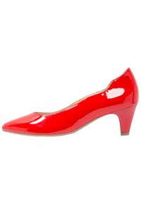 Escarpin en cuir verni rouge avec un bout pointu et un talon bas et épais. Présente une texture lisse et un design simple sans ornements.