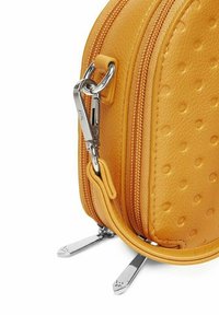 Yellow leather bag with a textured surface, two zippers, and silver hardware accents. Rounded shape and visible stitching details.