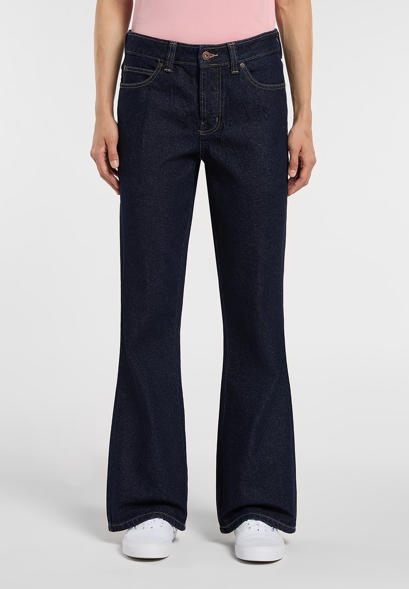 Flared dark blue jeans made of denim, featuring a classic five-pocket design, contrast stitching, and a button closure at the waist.