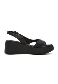 Sandale compensée plateforme en cuir noir avec bout ouvert, bride arrière et semelle épaisse.