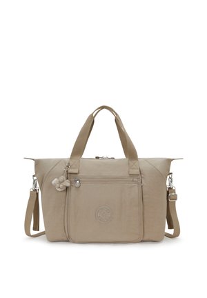 Sac fourre-tout beige avec double poignées, bandoulière ajustable, poche zippée avant et petit porte-clés en peluche attaché.