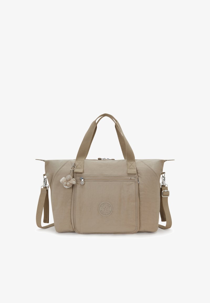Beżowa torba na ramię z podwójnymi uchwytami, regulowanym paskiem na ramię, przednią kieszenią na zamek oraz małą pluszową zawieszką do kluczy.