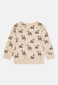 Sweatshirt beige chiaro con un motivo ripetuto di cammelli marroni e cactus blu. Realizzato in un tessuto morbido con polsini e orlo a coste.