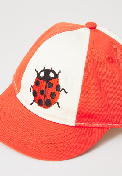Cap features a flat brim with orange and white panels, adorned with a black and red embroidered ladybug design. Fabric is textured cotton.