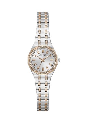 Montre pour femme en ton argent et or avec lunette en cristal, chiffres romains comme index et bracelet à maillons en métal affichant l'heure 10:09:35.