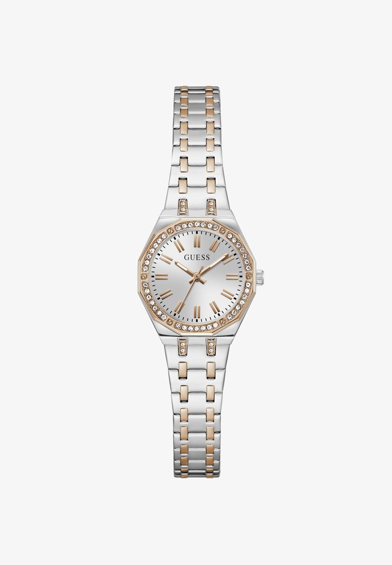 Montre pour femme en ton argent et or avec lunette en cristal, chiffres romains comme index et bracelet à maillons en métal affichant l'heure 10:09:35.