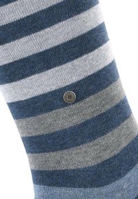 Sock with blue and gray striped pattern, a textured knit, and a small metal logo attached at the cuff.