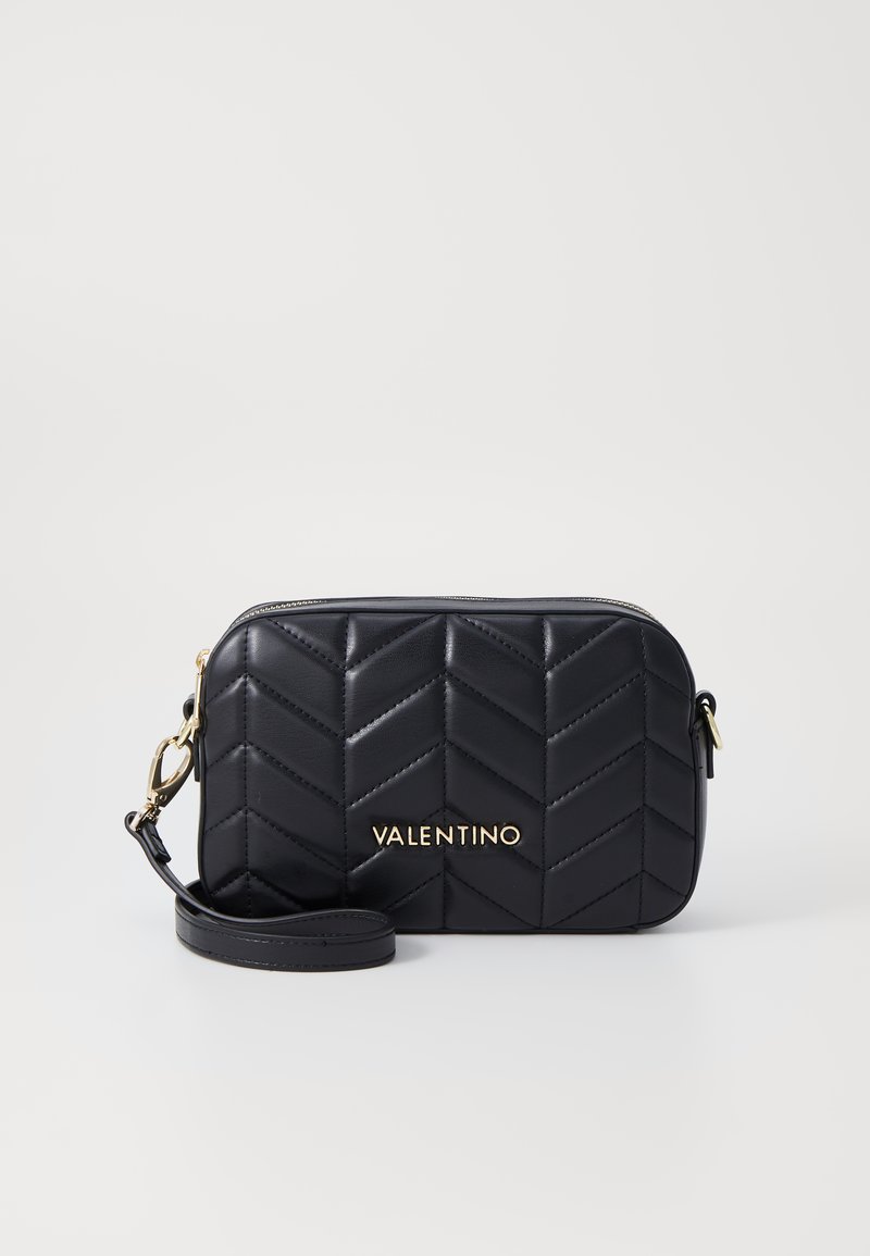 Mustassa nahkaisessa poikittain kannettavassa laukussa on tikattu chevron-kuviointi, kultainen "Valentino"-logo, irrotettava hihna ja vetoketjulla suljettava osa.