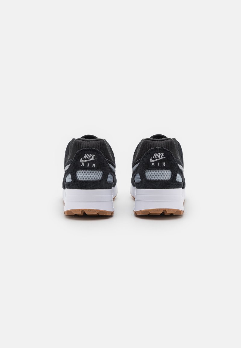 Nike Air sneakers featuring a black suede upper, gray mesh accents, white midsole, and gum rubber outsole. Logo displayed on the heel.