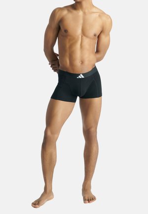 Schwarze Shorts aus dehnbarem Material, ausgestattet mit einem elastischen Bund und einem weißen Adidas-Logo sowie einem taillierten Design für optimalen Komfort.