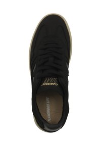 Black sneaker with a textured fabric upper, white accents, a rounded toe, and a beige sole. Features "FLAMINGOS LIFE" in gold on the tongue.