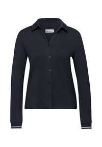 Chemise noire à manches longues avec col et boutons, comportant des rayures blanches subtiles sur les poignets, présentée sur un fond blanc uni.