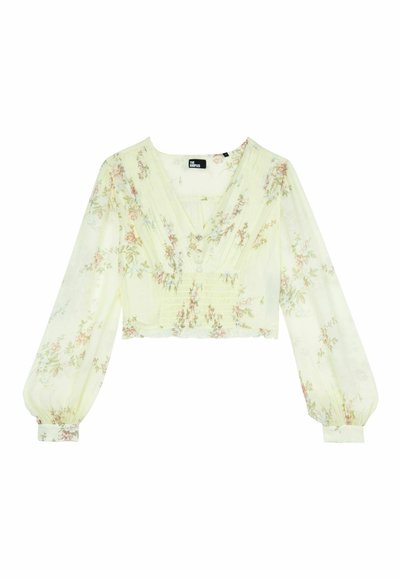 Cropped top in tessuto giallo chiaro, con motivi floreali, maniche lunghe a palloncino, scollatura a V profonda e dettagli plissettati sul davanti.