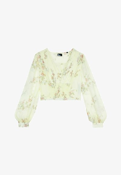 Cropped top in tessuto giallo chiaro, con motivi floreali, maniche lunghe a palloncino, scollatura a V profonda e dettagli plissettati sul davanti.