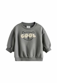 Felpa grigia con maniche a sbuffo, polsini e orlo a coste. Presenta una grafica di un orso con la scritta "COOL" in materiale crema testurizzato.